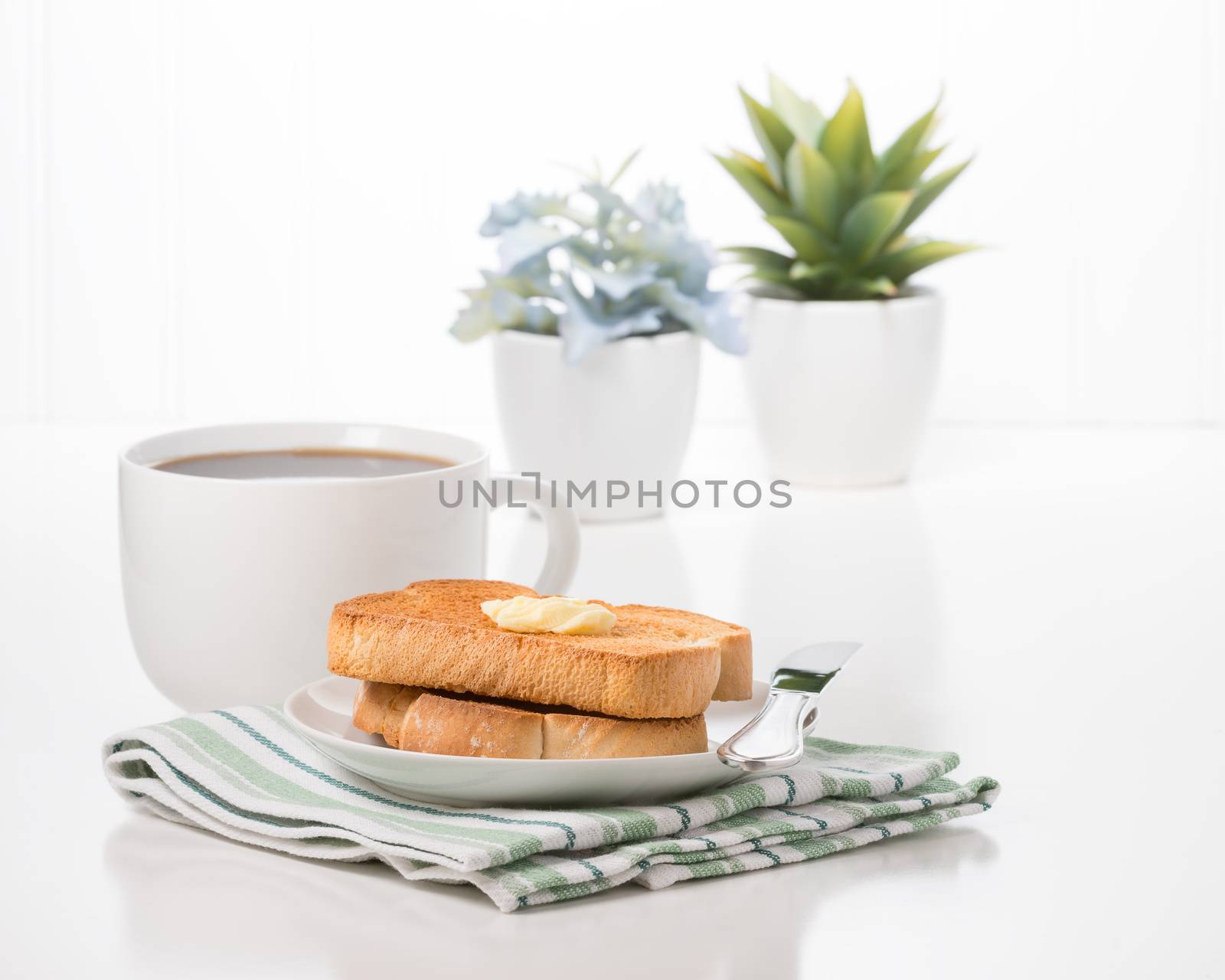 Toast with butter and a cup of hot coffee.