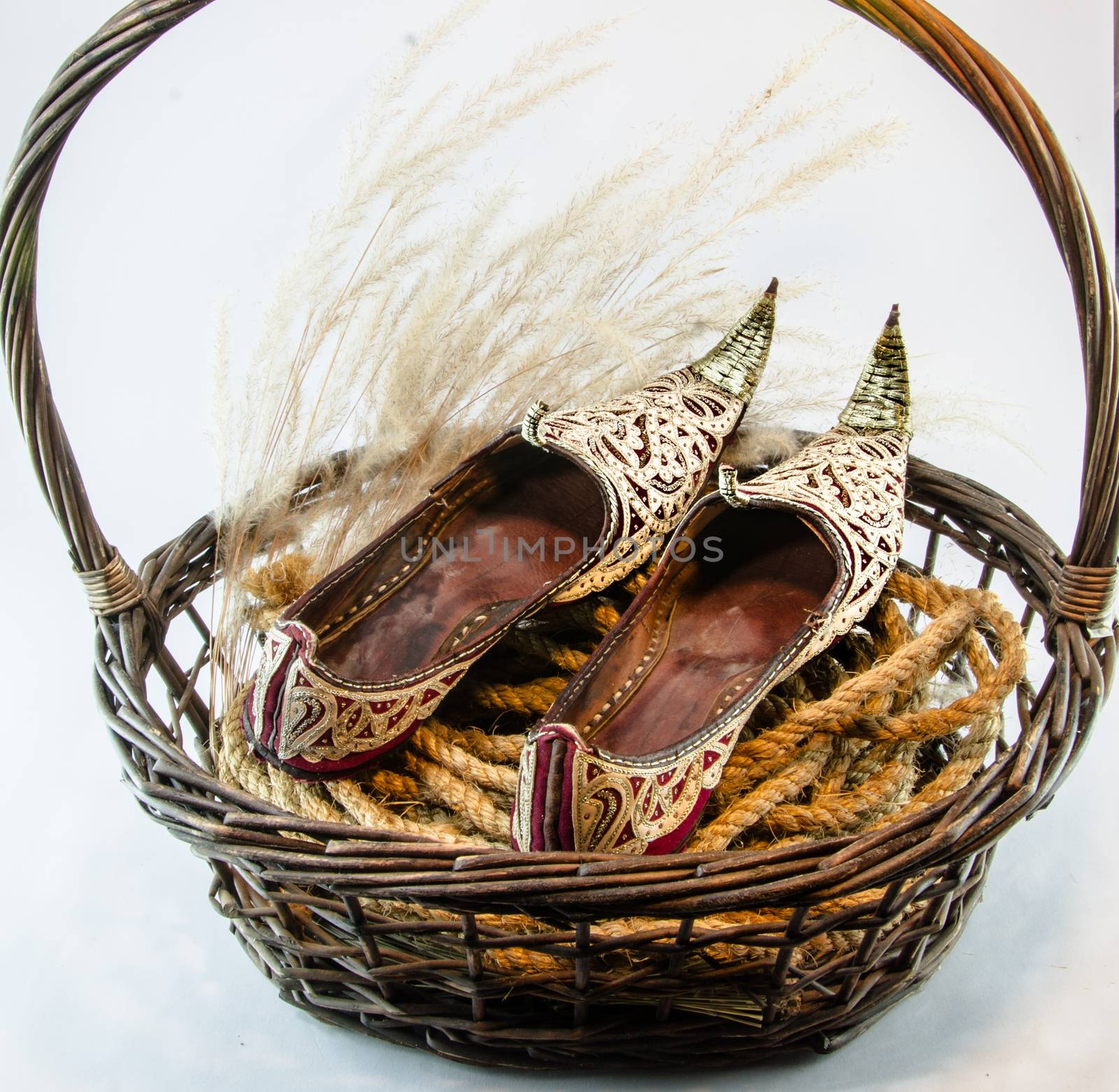 Indian shoe king wicker brown basket isolated on white