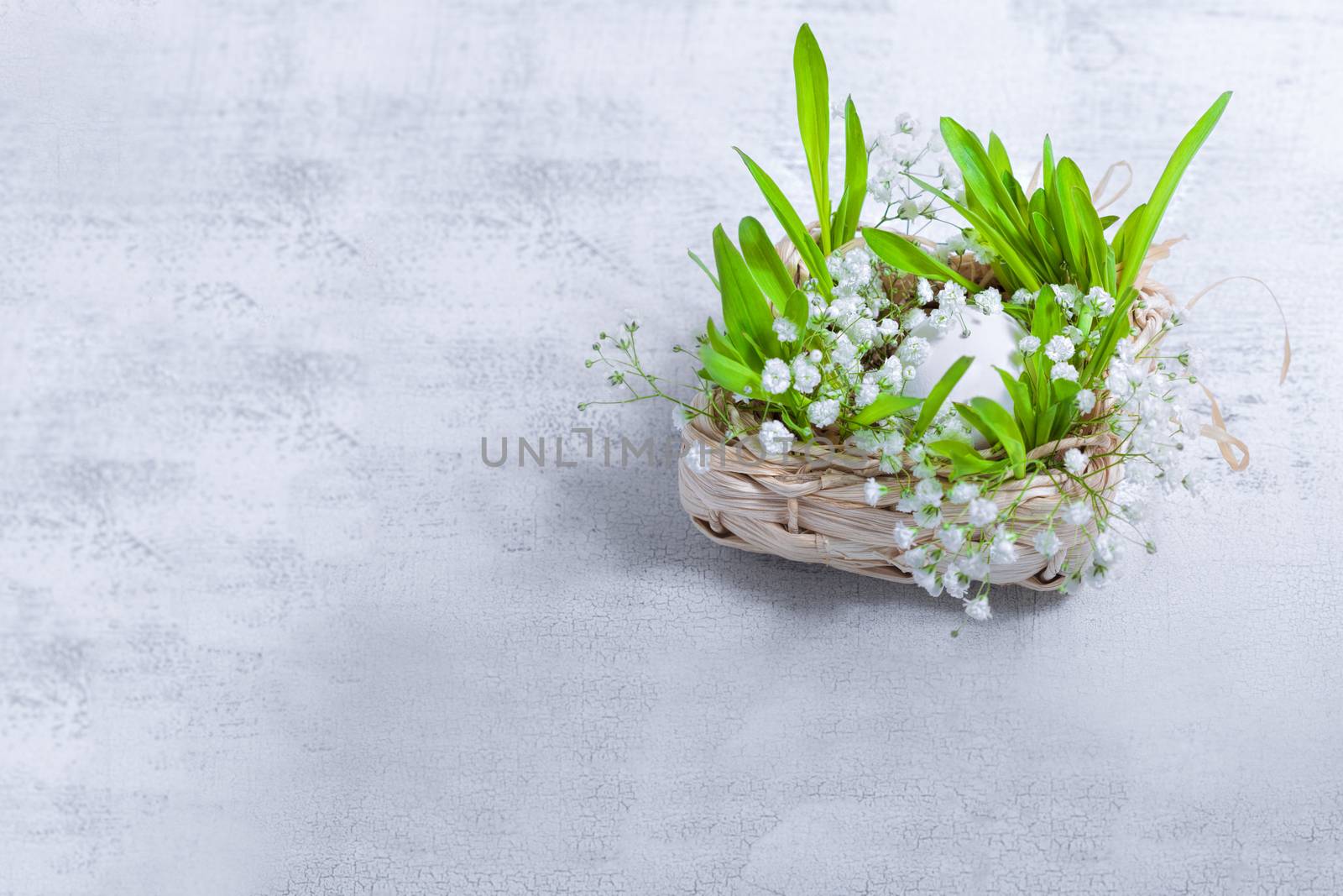 Easter symbols including flowers and egg on a white background
