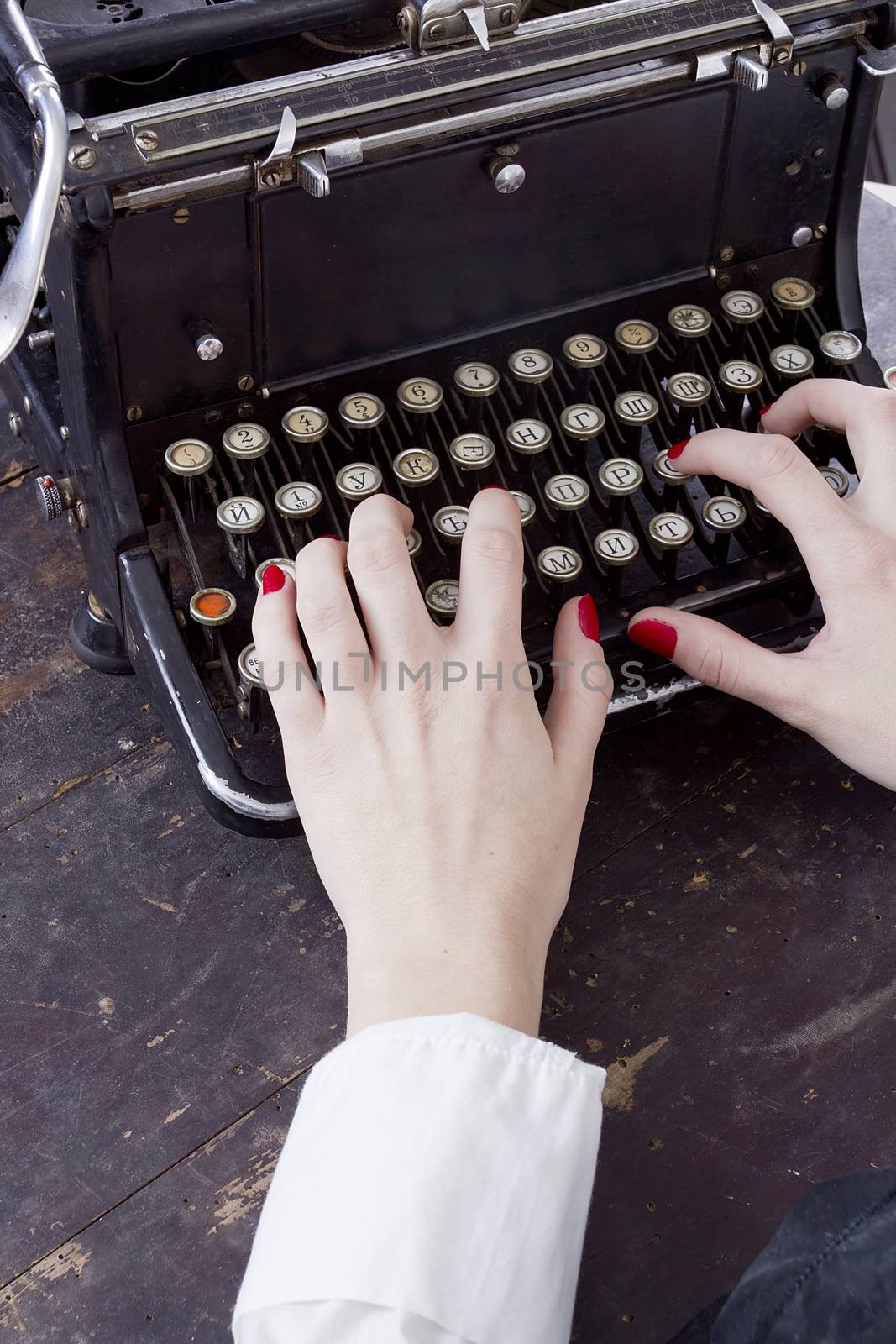 Hands of a young woman printed on a typewriter by VIPDesignUSA