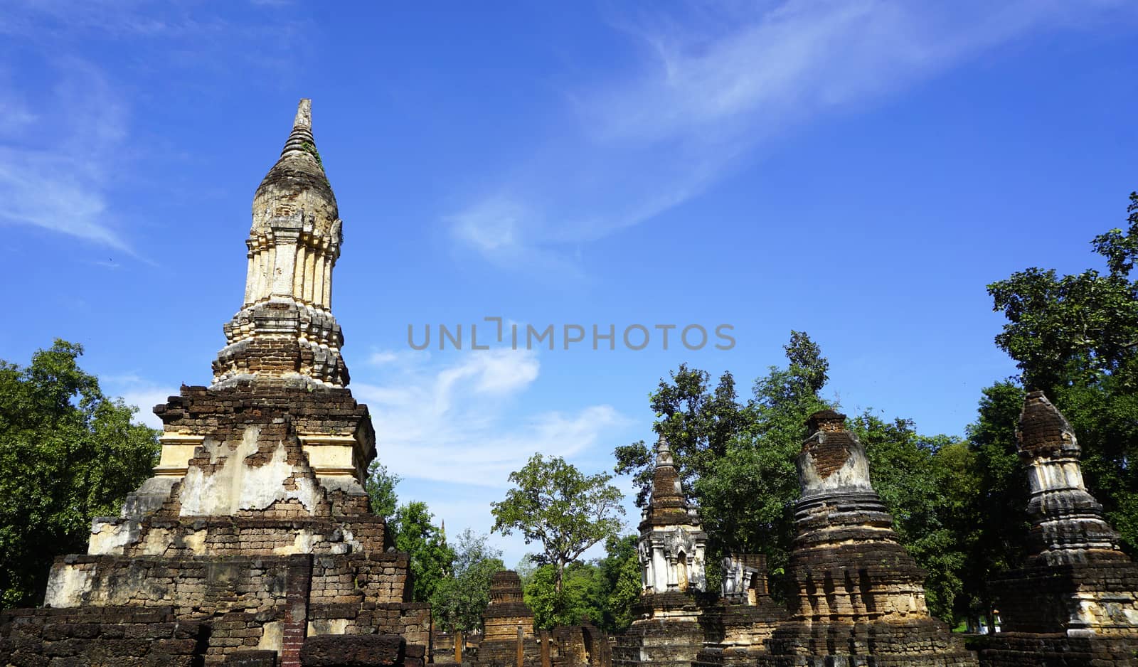 Historical Pagoda Wat chedi seven rows temple in Sukhothai  by polarbearstudio