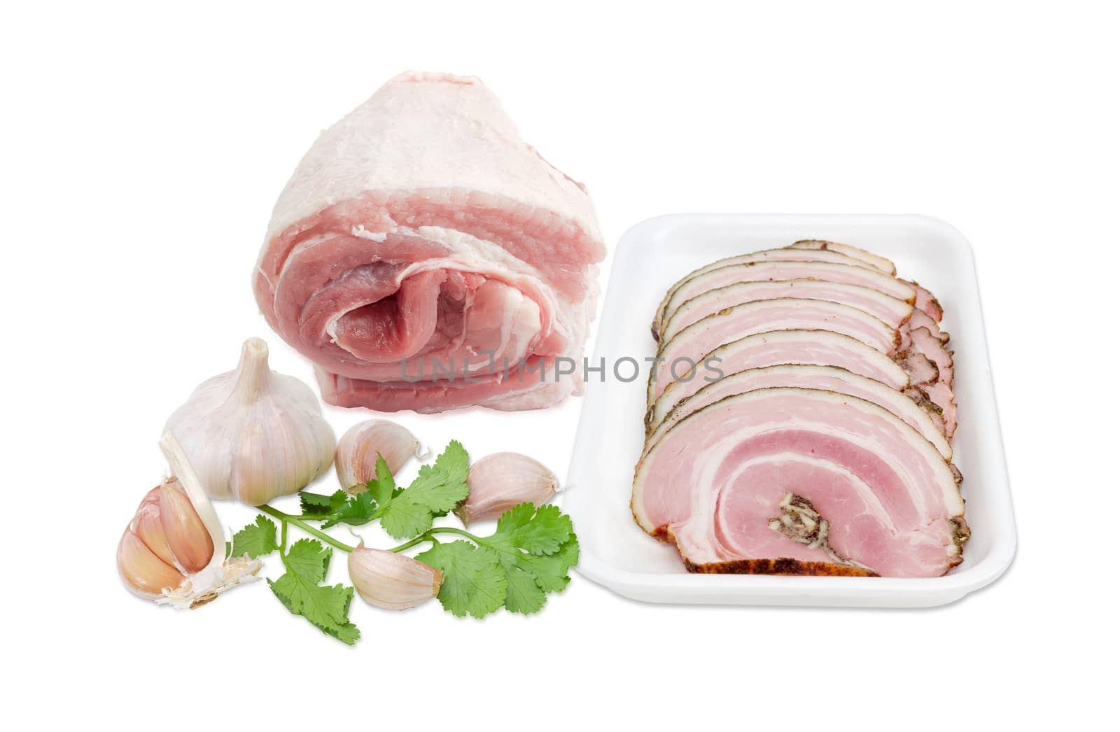 Sliced roll of a baked pork belly on a plastic tray, roll of a uncooked pork belly, garlic and coriander on a light background 
