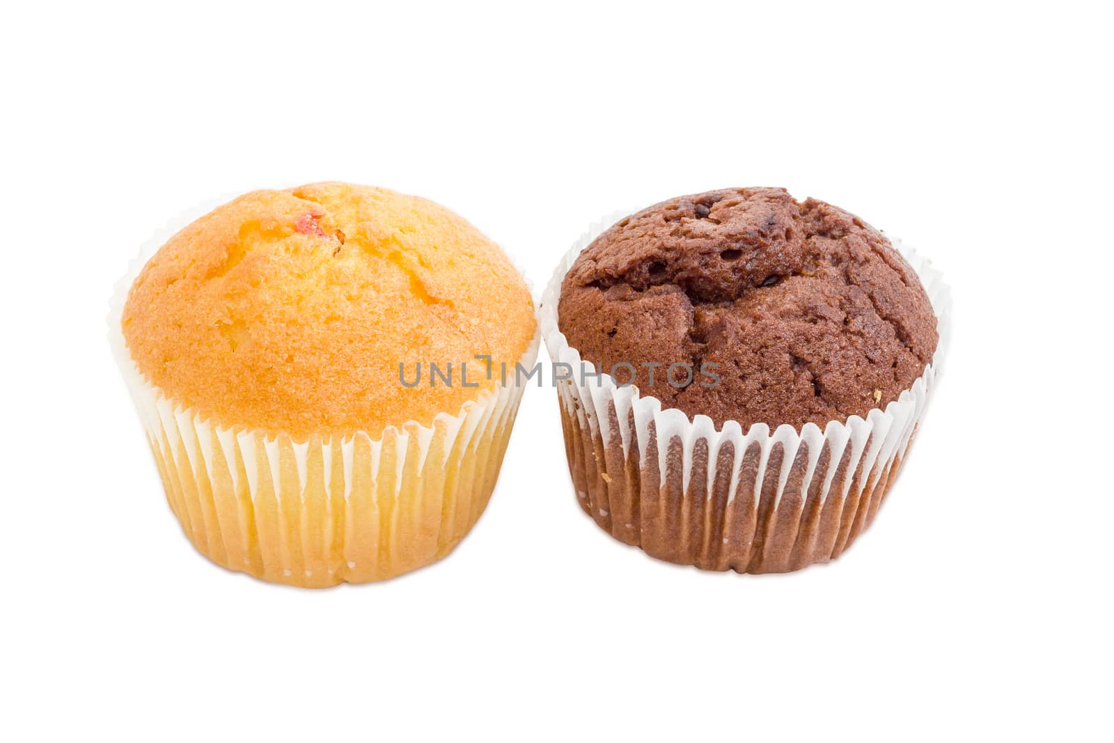 One sweet muffin with jam and one chocolate muffin in a paper cups on a light background
