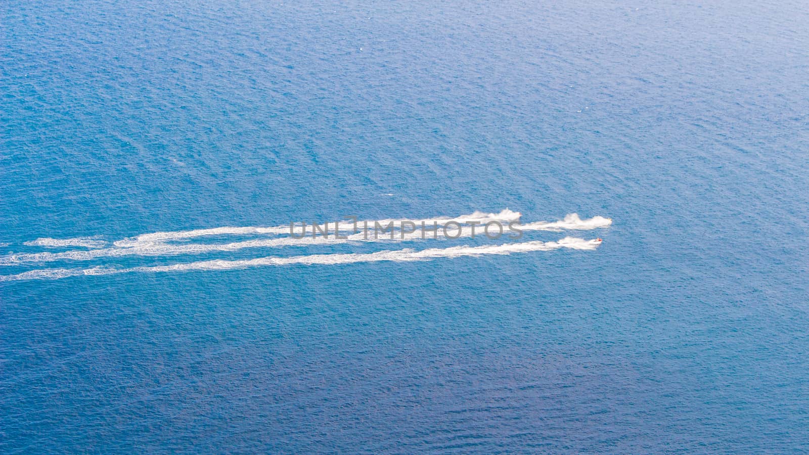 Speedboat cruising over the blue Mediterranean Sea