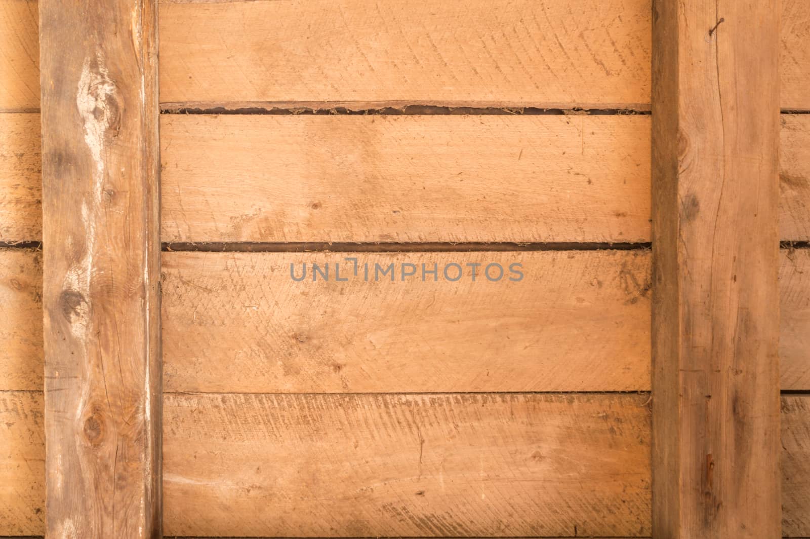 Wooden boards inside an old outbuilding with beams and horizontal arrangement