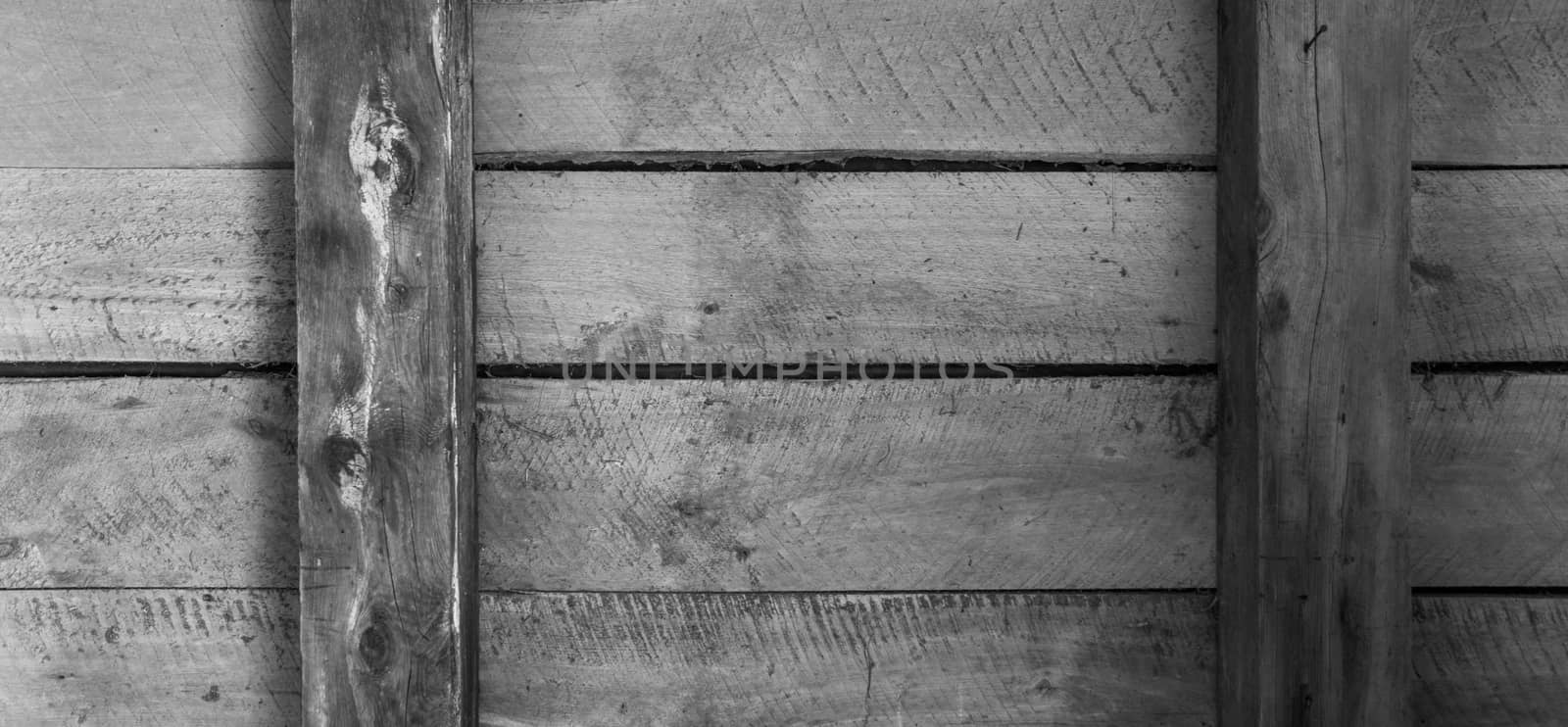 Four wooden boards inside an old outbuilding twobeams and horizontal arrangement