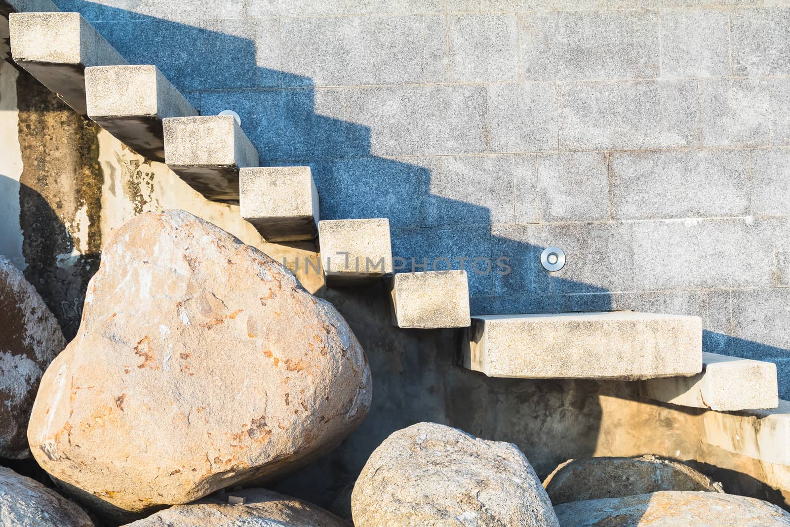 stone and concrete ladder on beach to house