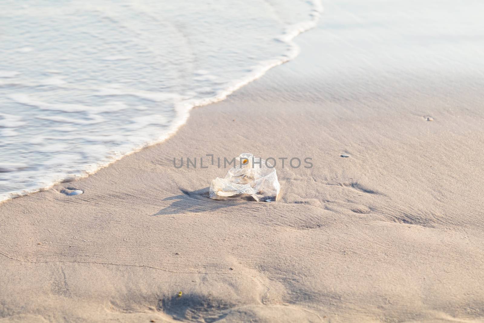 used plastic bag on the beach by luckyfim