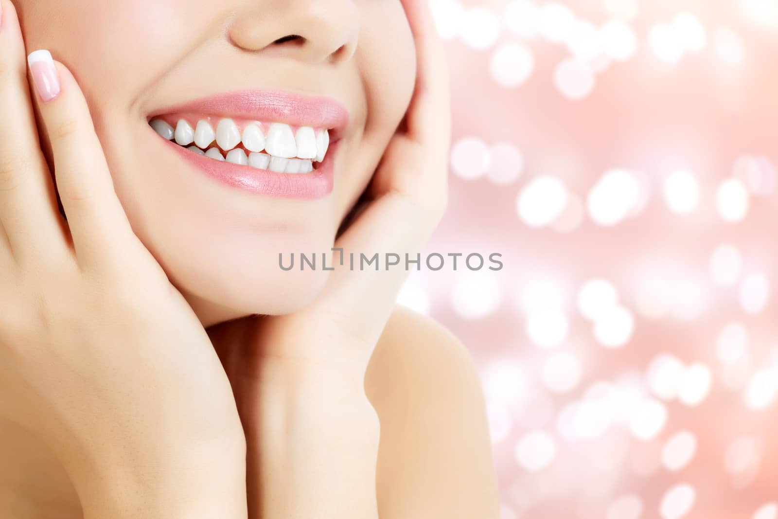 Happy woman smiling on an abstract background with blurred lights