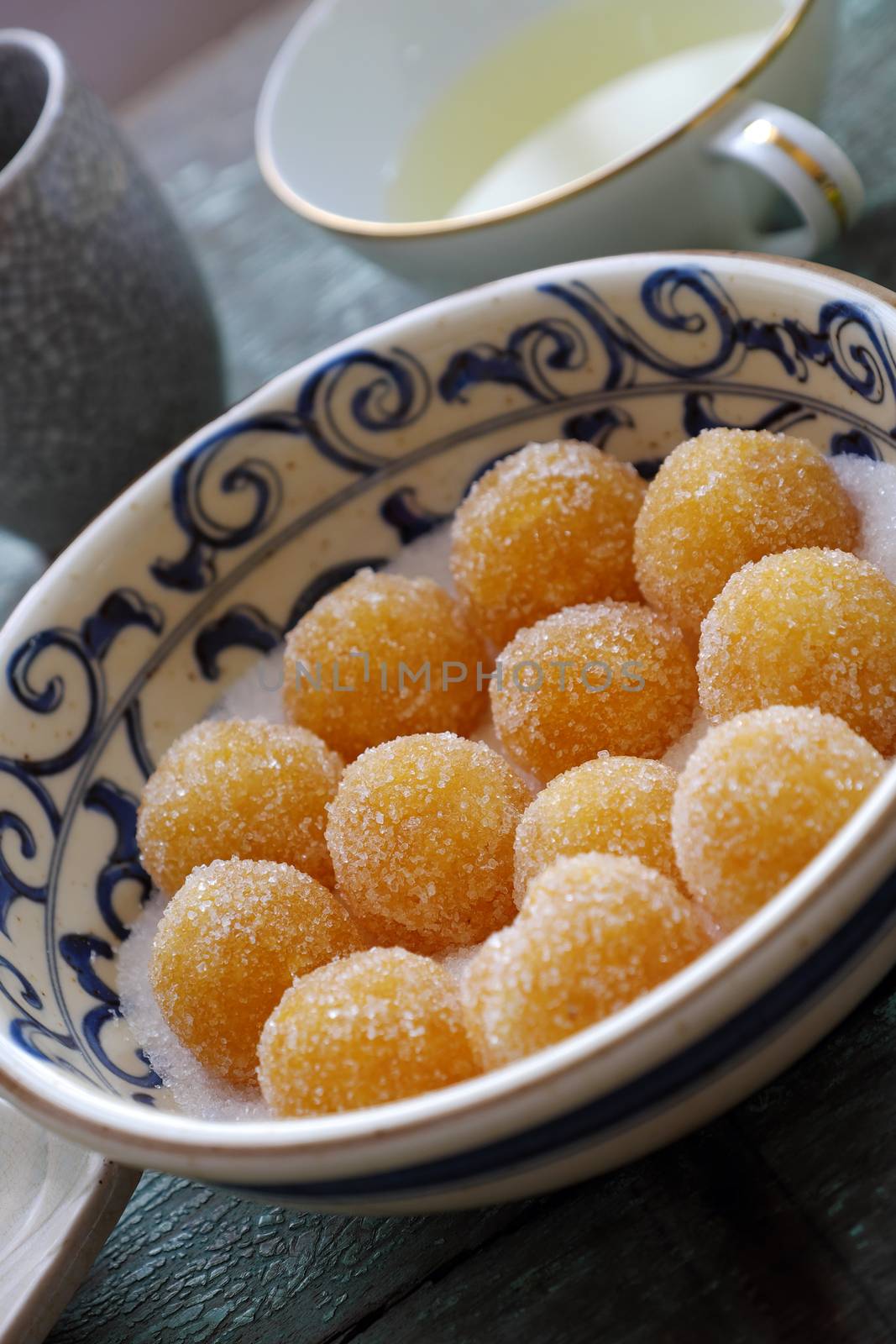 Vietnamese sweet food for tet holiday, home made pineapple jam in ball on wooden background, a traditional eating for lunar new year in Vietnam