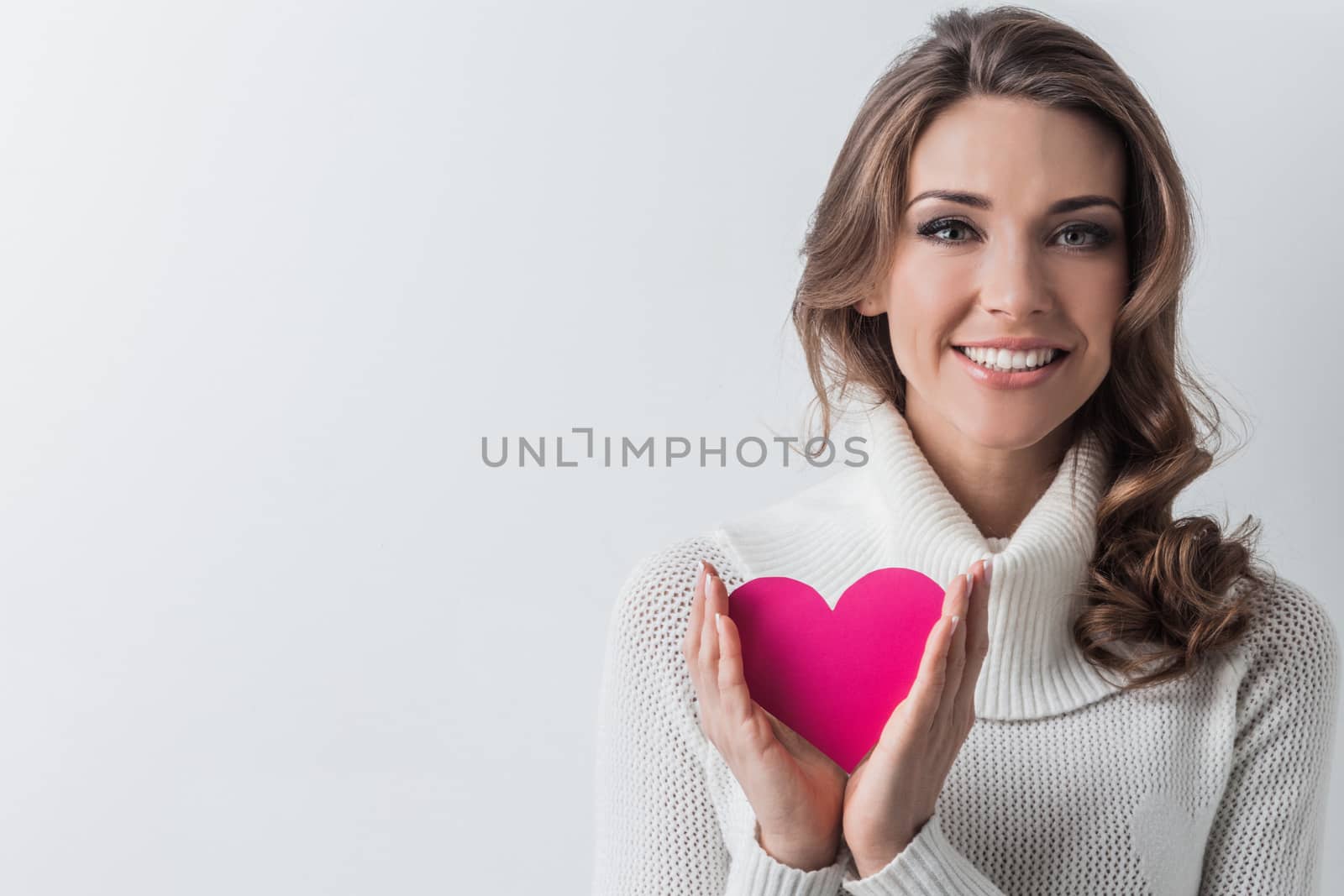 Smiling woman with paper heart by Yellowj