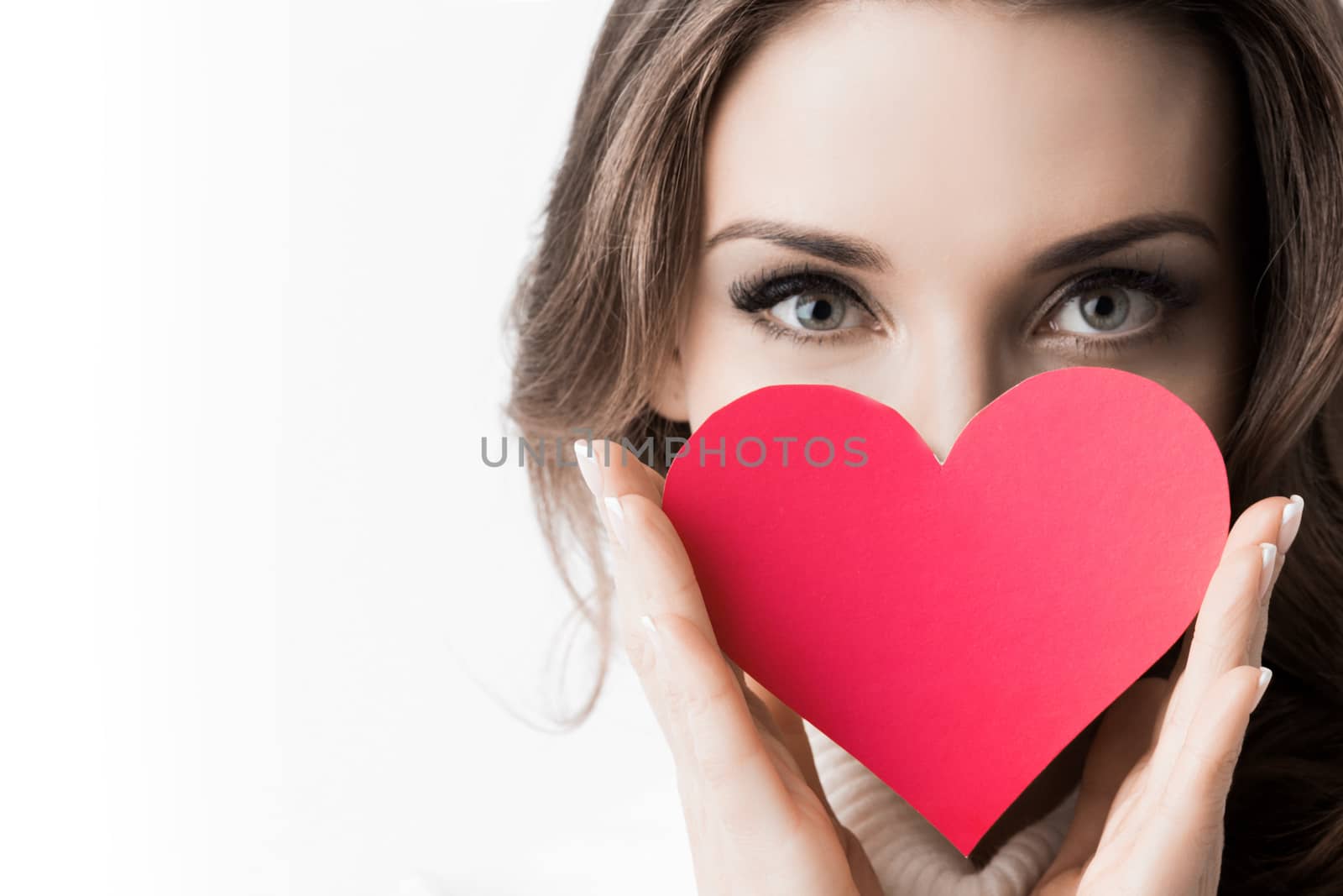 Portrait of girl holding red paper heart isolated on white background