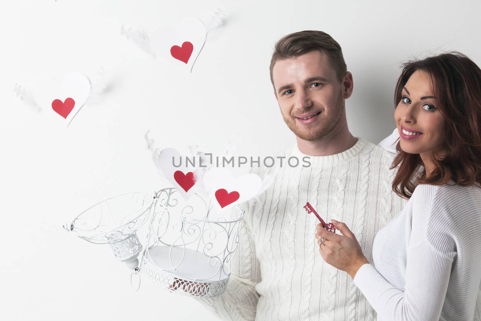 Couple releasing love, man and woman open cage with winged hearts, valentines day concept