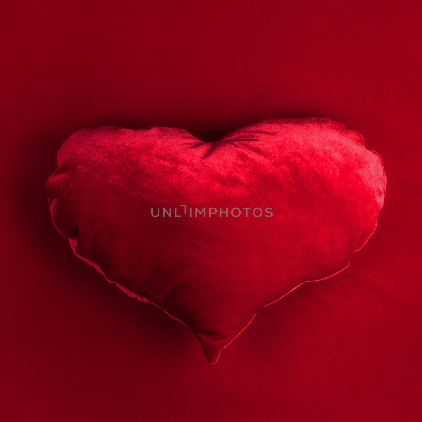 Red pillow heart on red fabric background, Valentines day