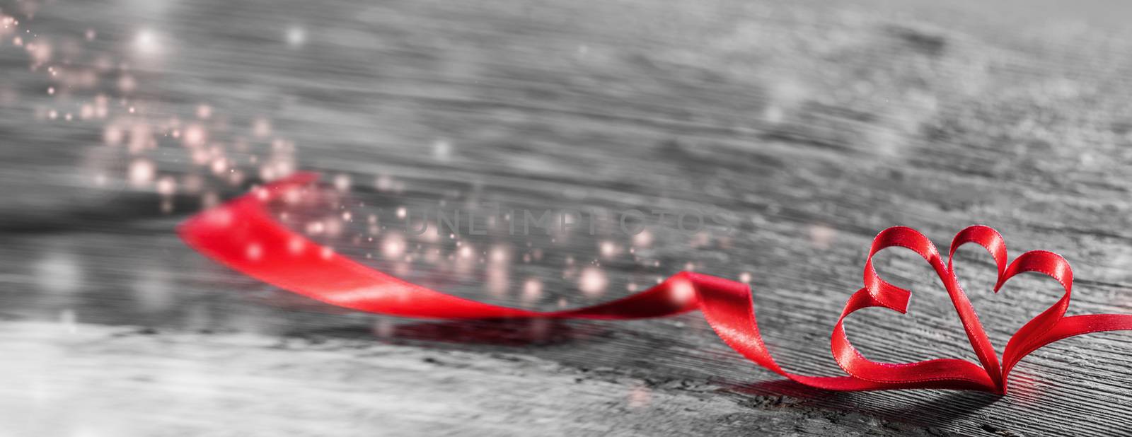 Two red ribbon magic hearts on wooden backround, Valentine day concept