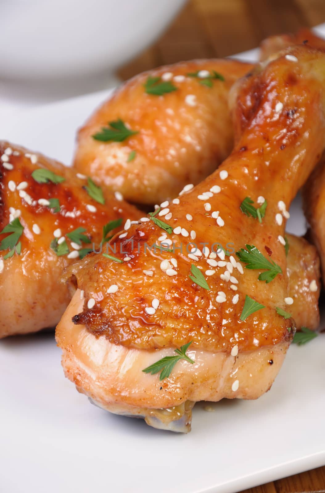 Fried chicken leg with sesame seeds in a plate closeup
