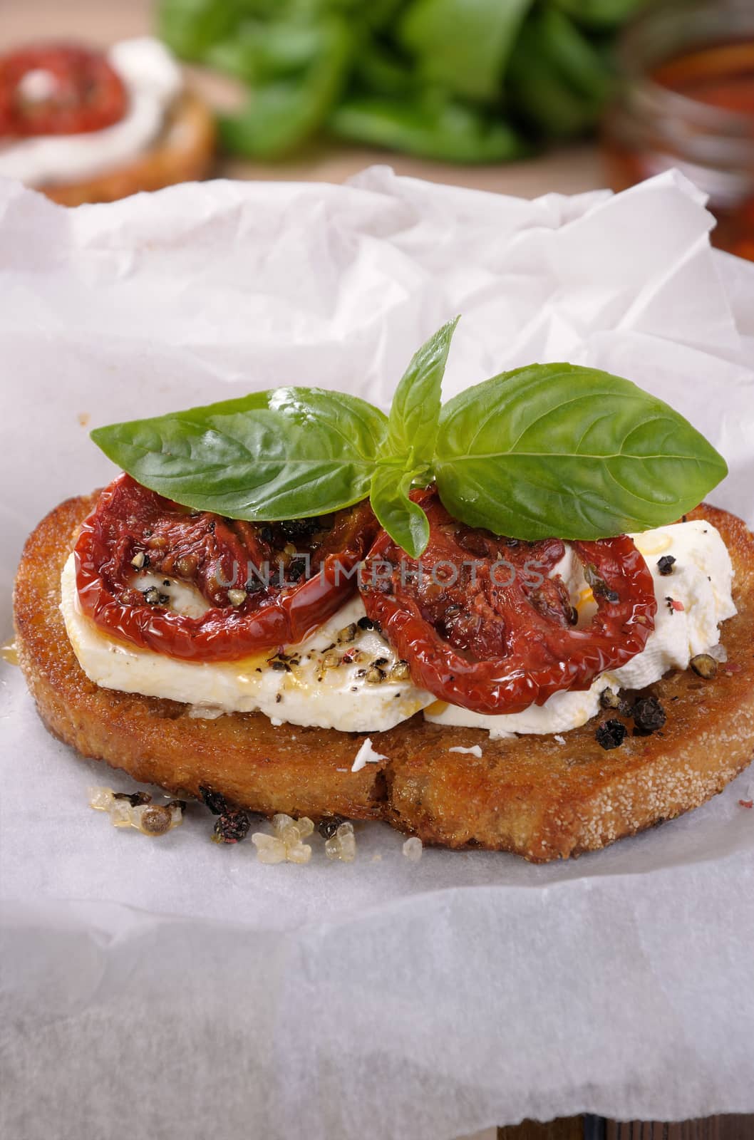 Bruschetta with feta and sun-dried tomatoes slices spiced