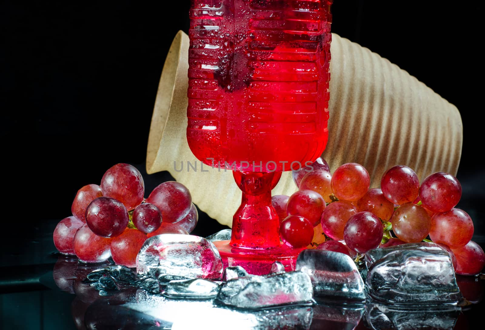 Grape glasses  red wine  closeup a black background.