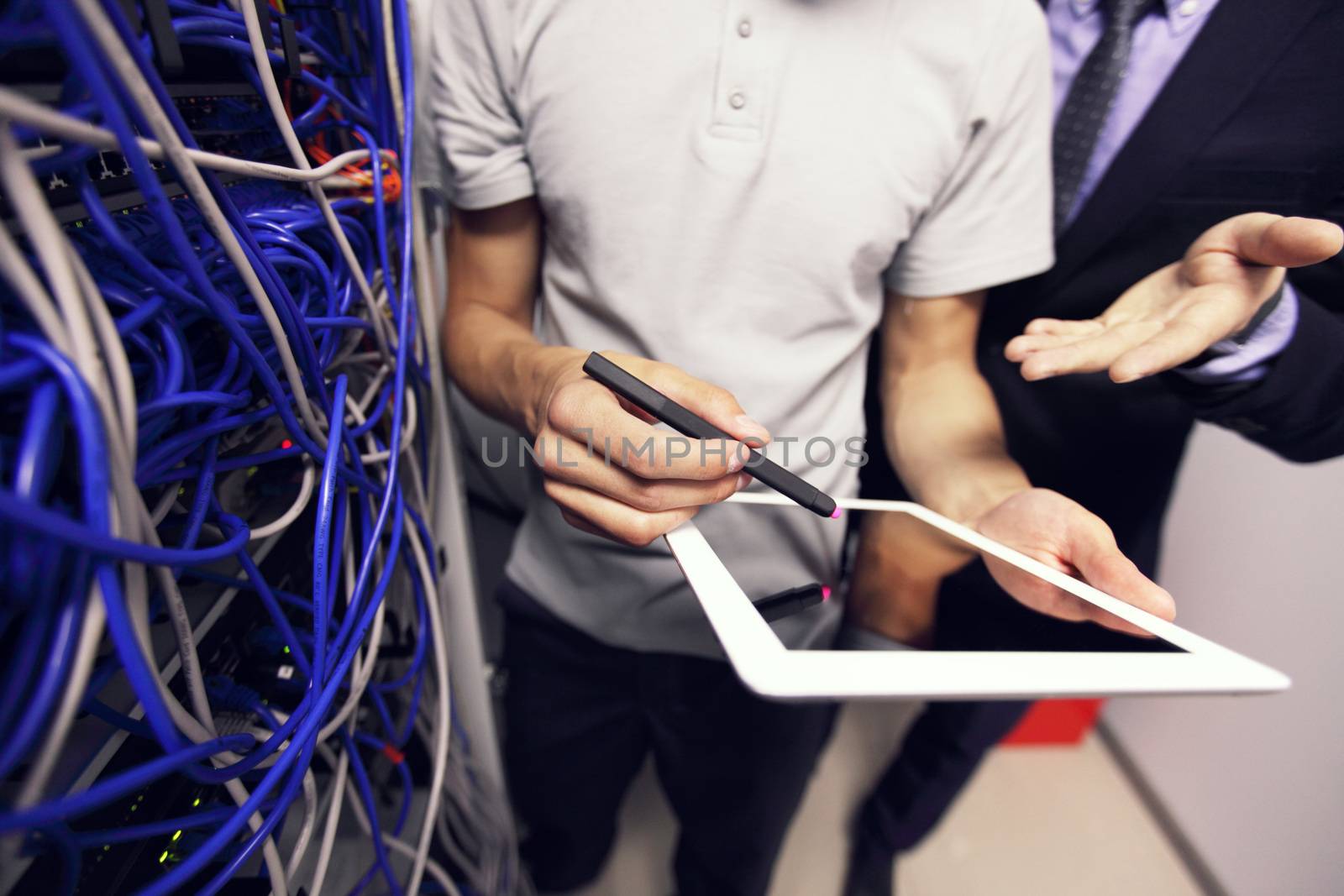 Engeneer and business man in network server room with digital tablet