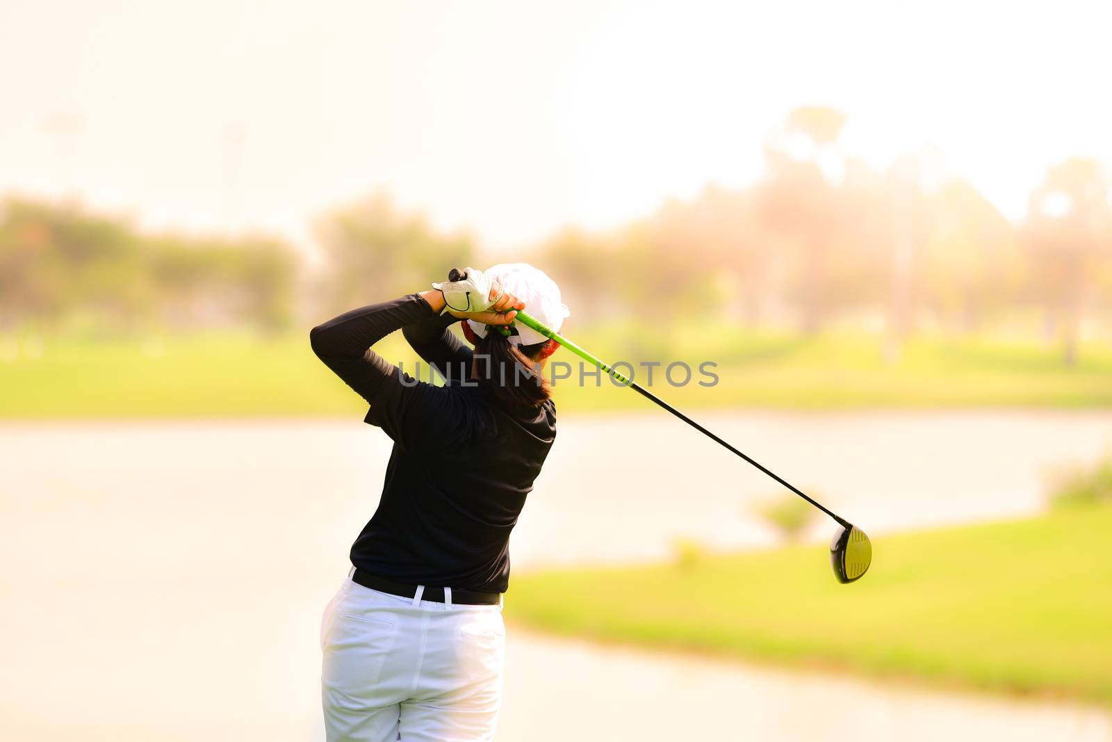 Golfer hitting golf shot. by chatchai