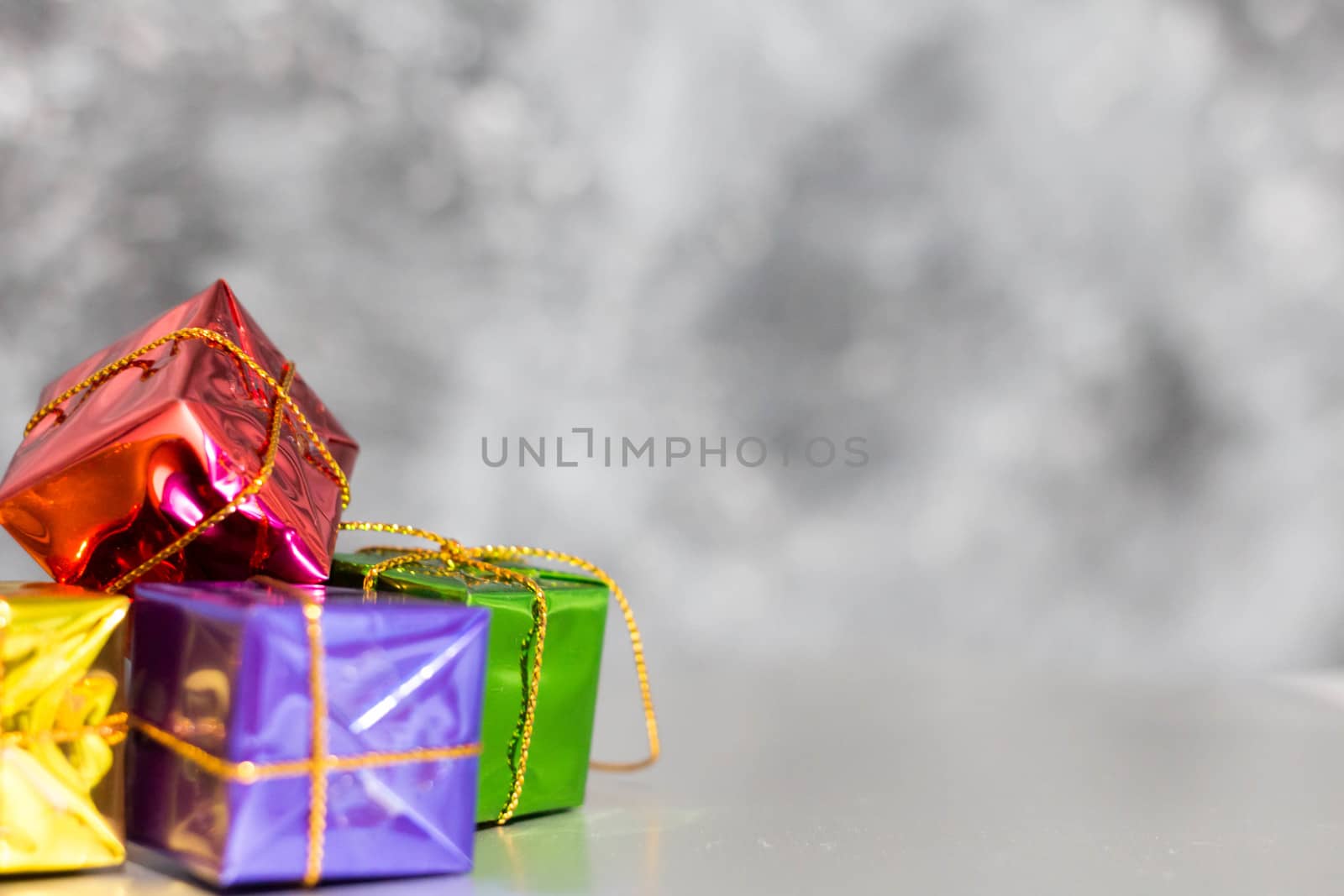 Gift Box And Baubles On Snow With Shiny Background