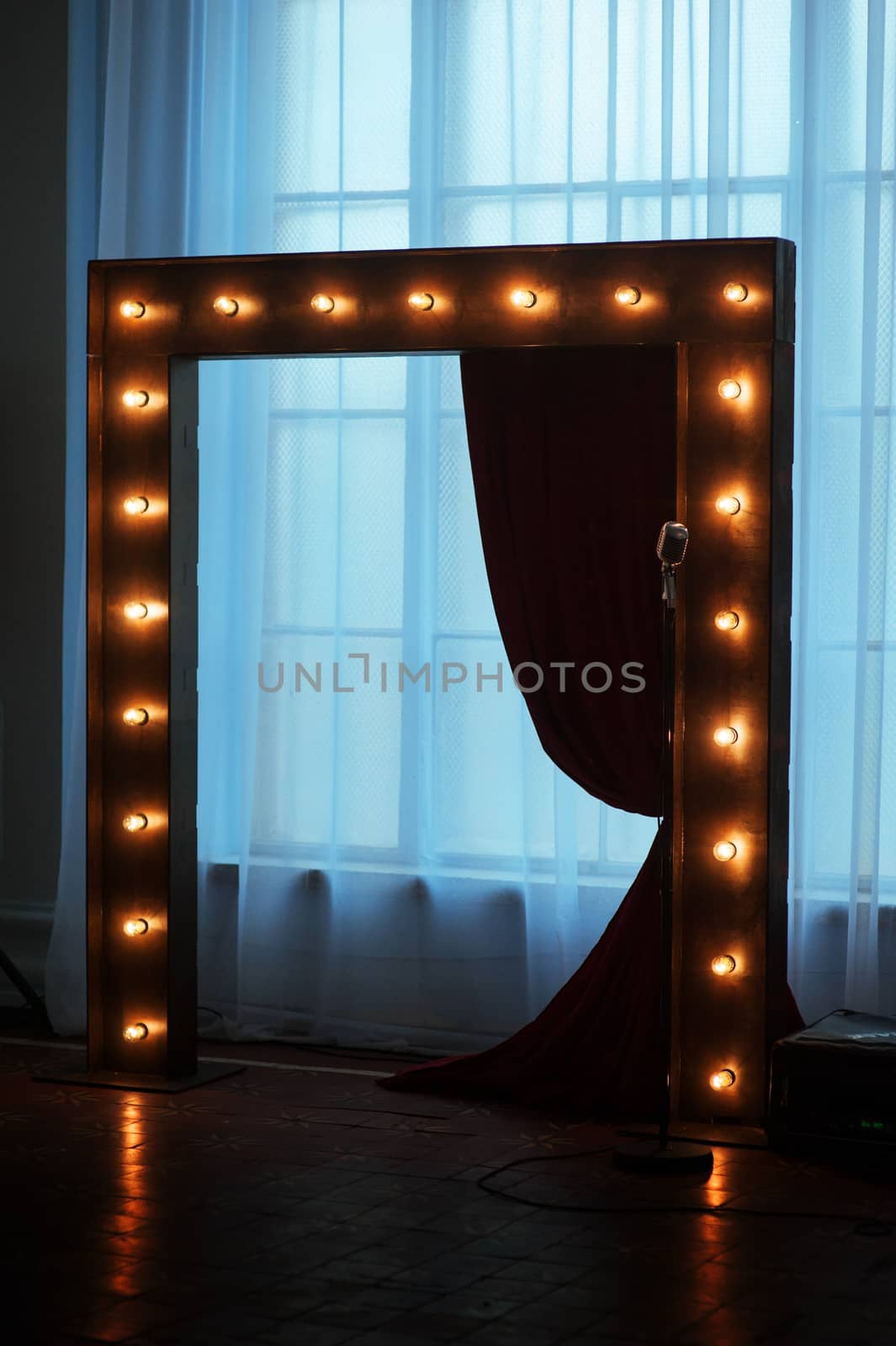 wooden arch with lights adorned for wedding ceremony.
