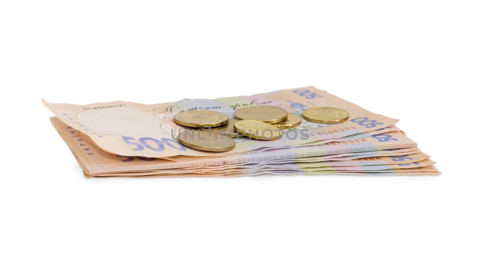 Stack of modern banknotes of Ukrainian hryvnia, some of them new and several coins from above closeup on a light background
