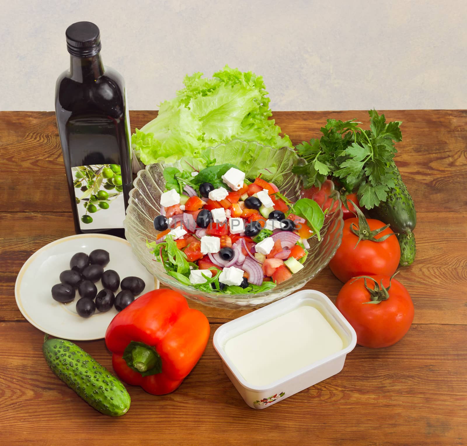 Greek salad among ingredients for its cooking on wooden surface by anmbph