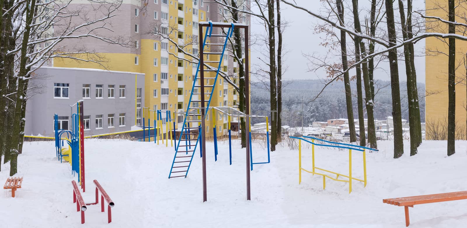 Outdoor gym in winter public park near the apartment complex by anmbph