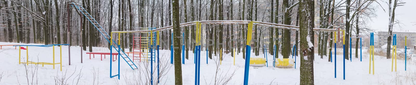 Outdoor gym in winter public park near the residential area by anmbph