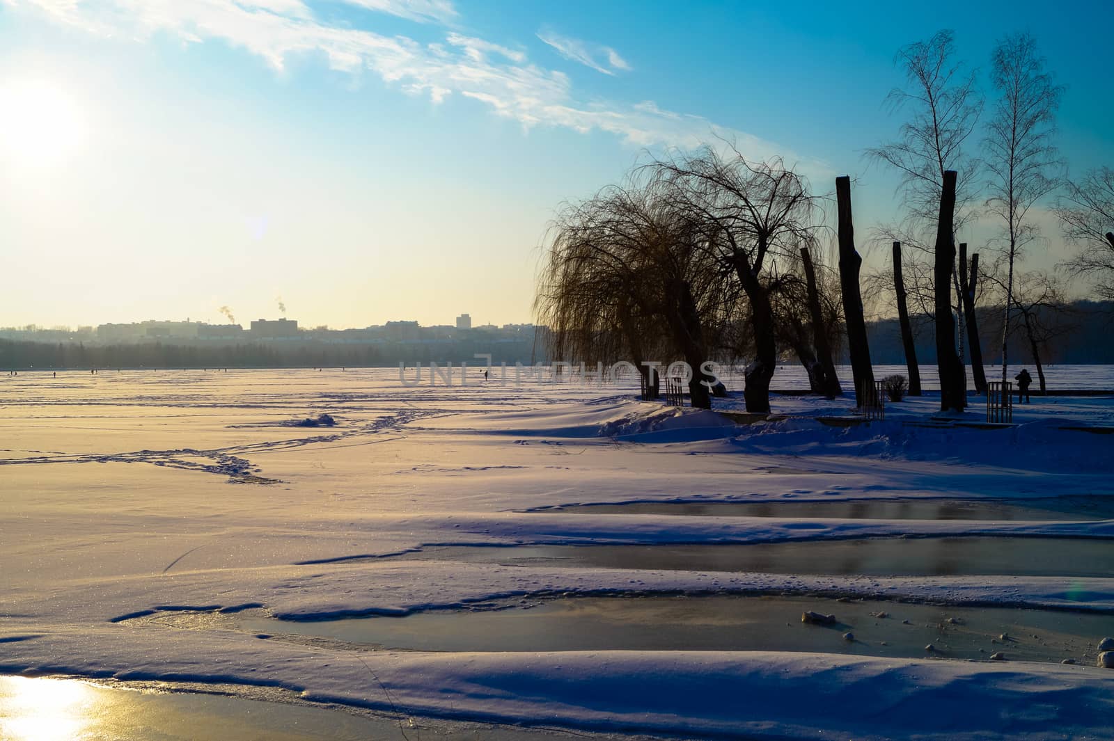 the beautiful landscape of the lake is covered with ice in the center of the city by Oleczka11