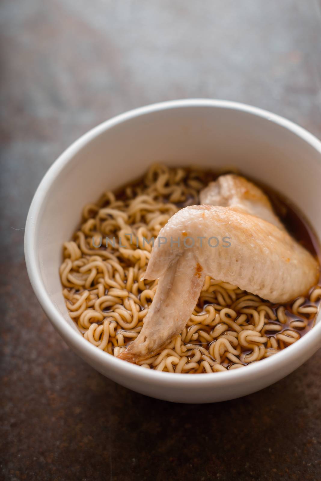 Soup Ramen noodle with chicken wing in ceramic bowl vertical