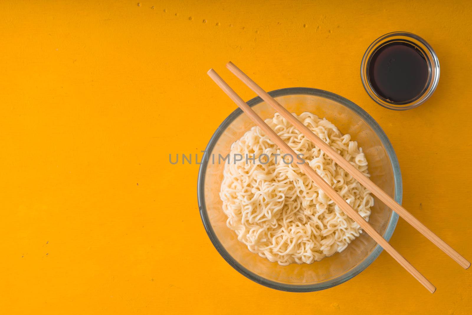 Soup Ramen noodles in glass bowl and soy sause by Deniskarpenkov
