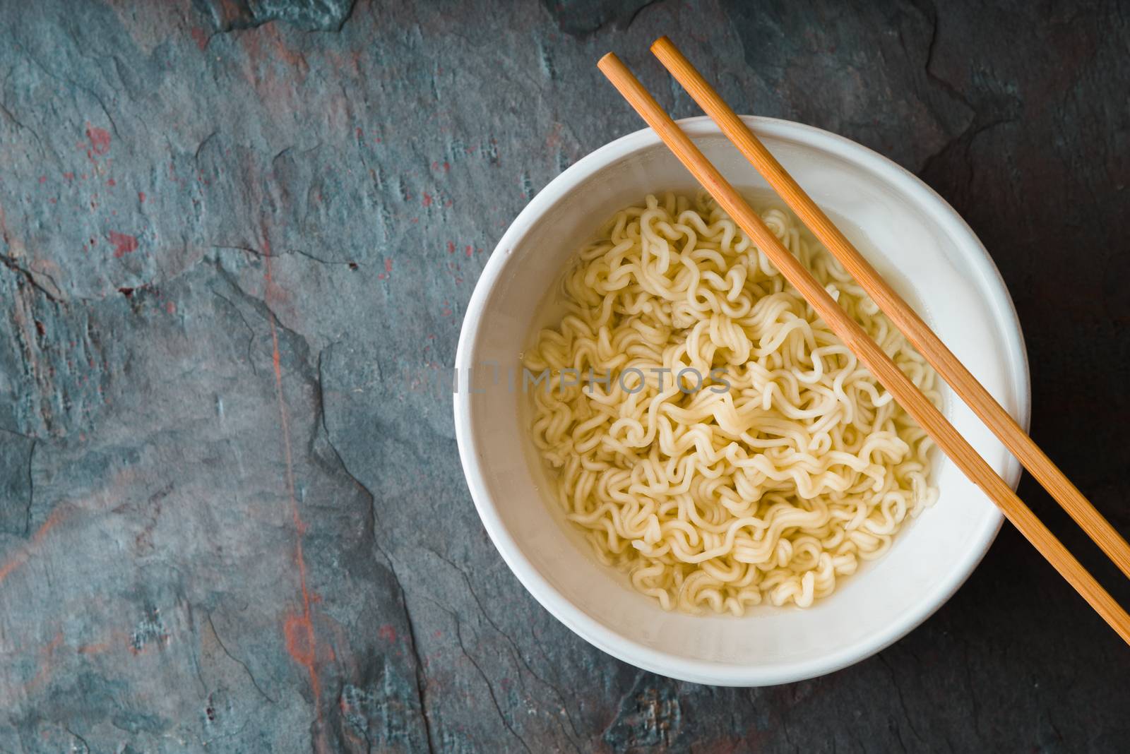 Soup Ramen noodles in ceramic bowl and bamboo sticks horizontal
