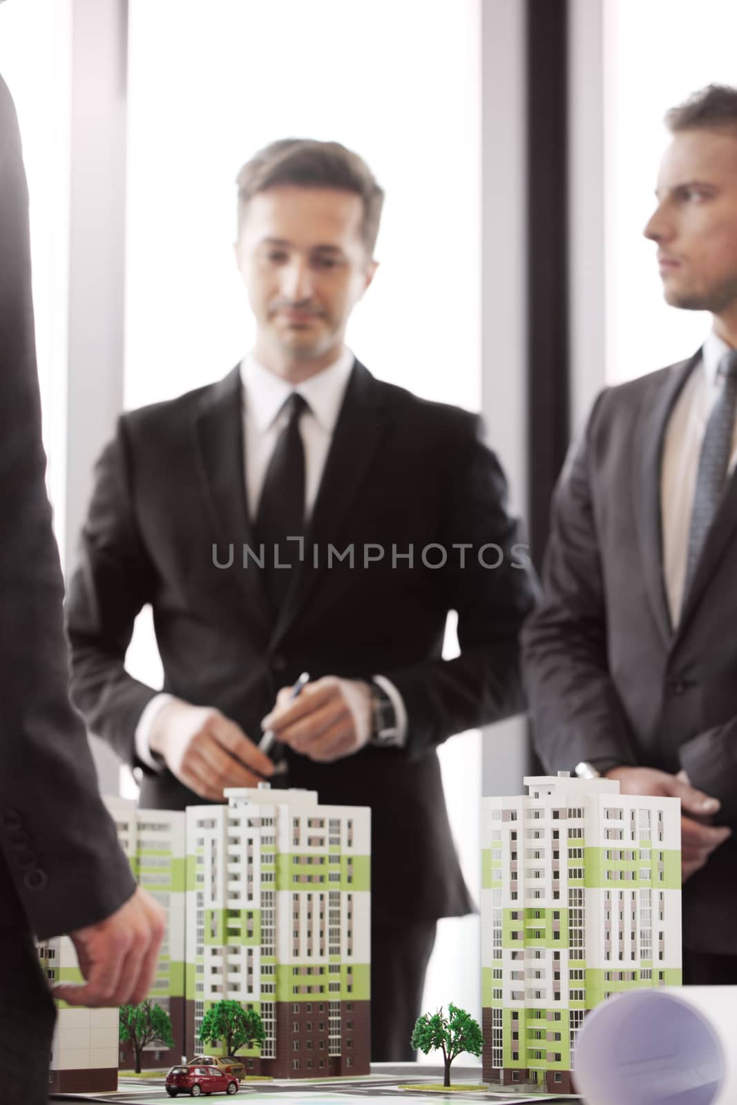 Business people and apartment house model by ALotOfPeople