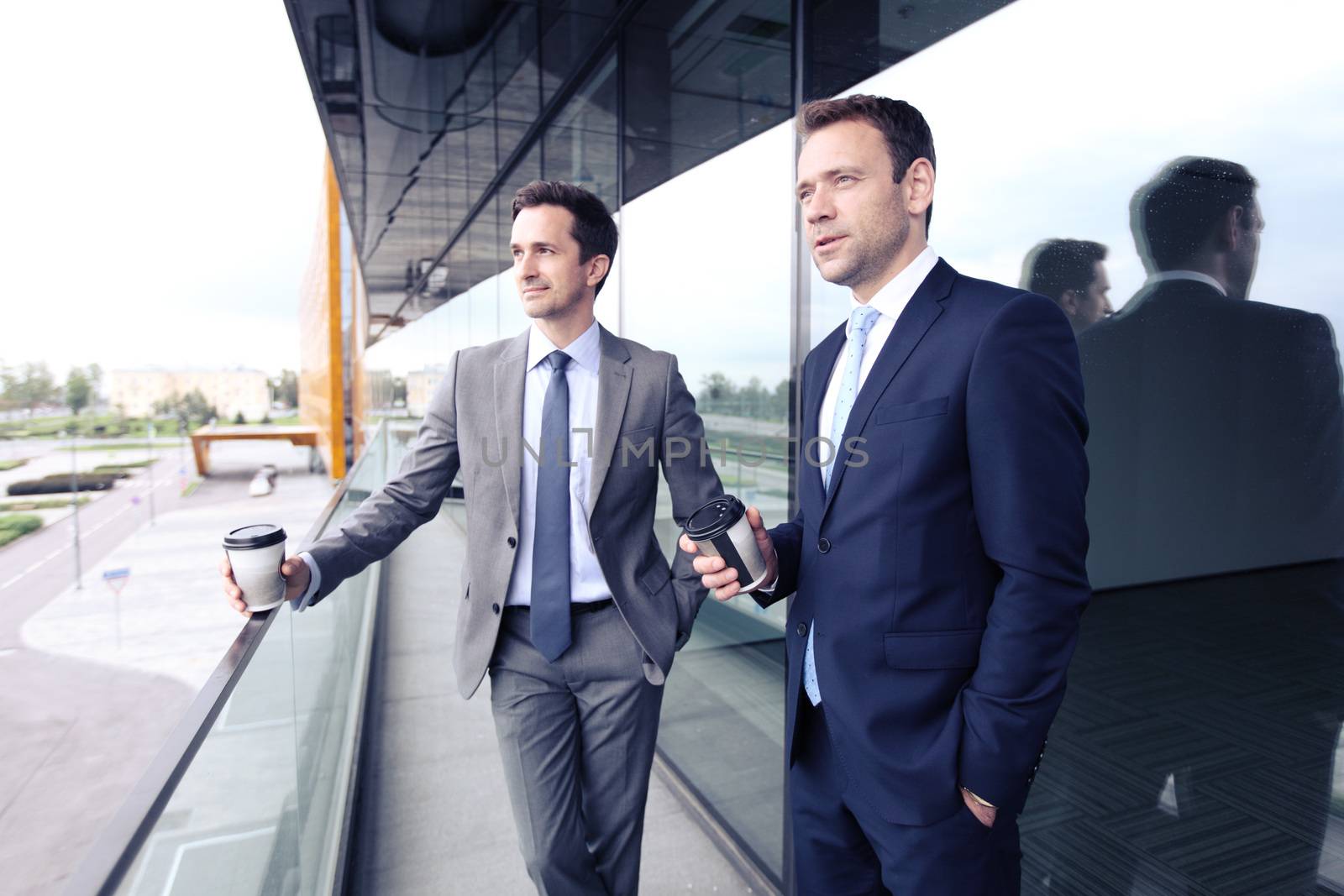 Business people having coffee break at the balcony of office building