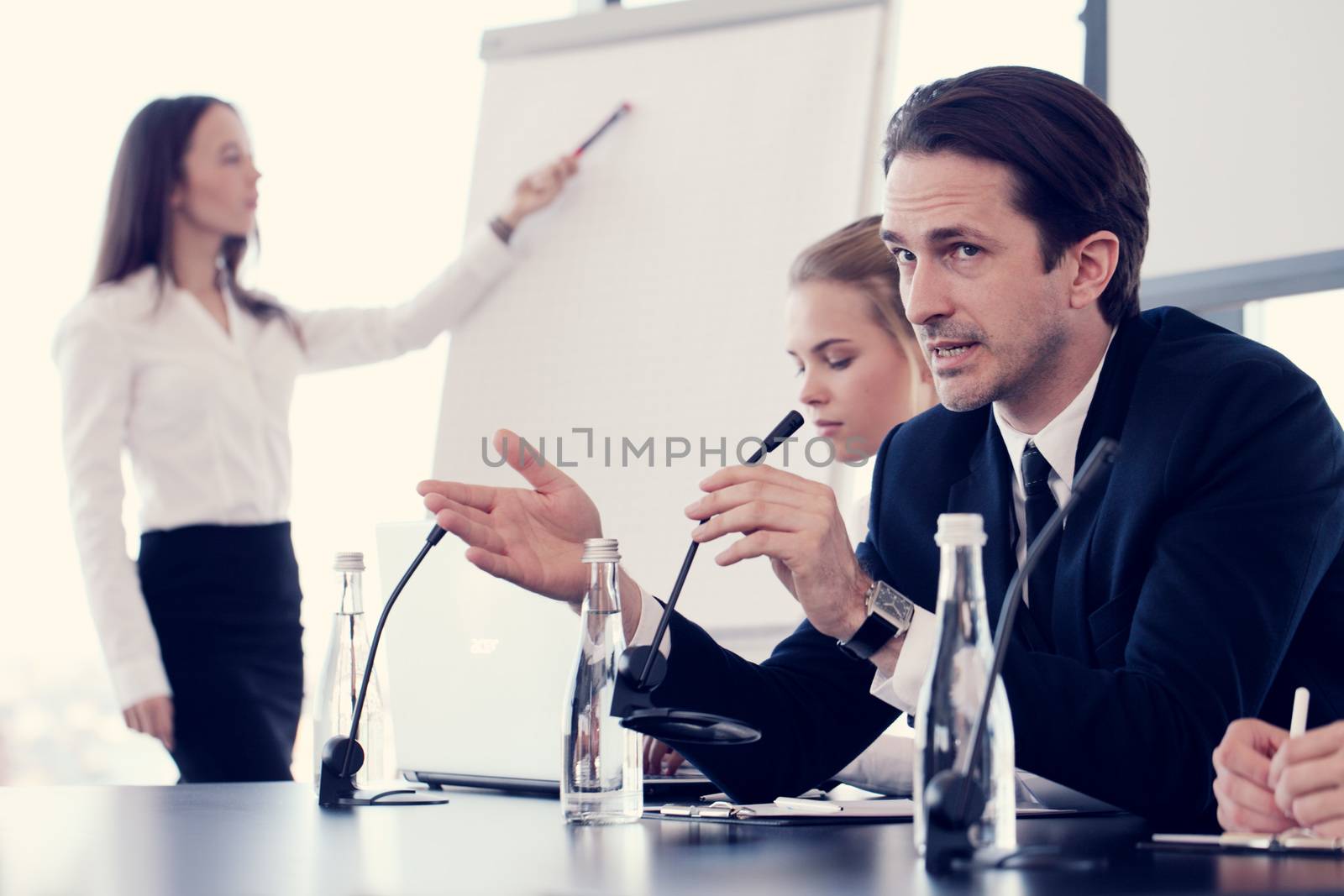 Business man speaking in microphone at presentation conference