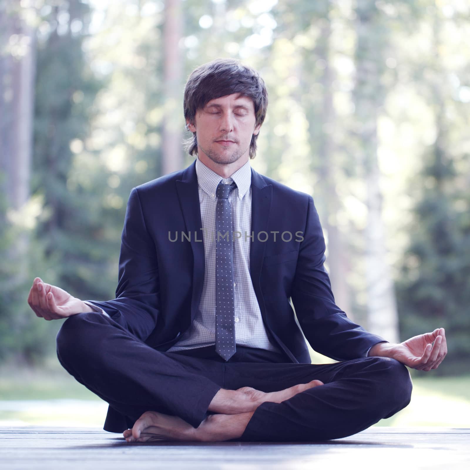 Businessman practicing yoga by ALotOfPeople