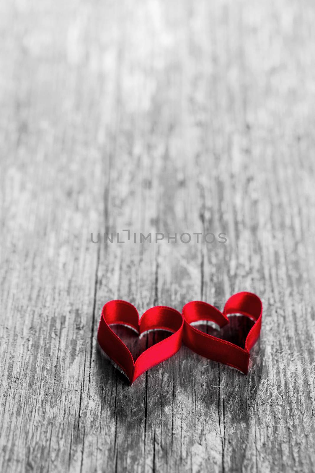 Two ribbon hearts on wood by Yellowj