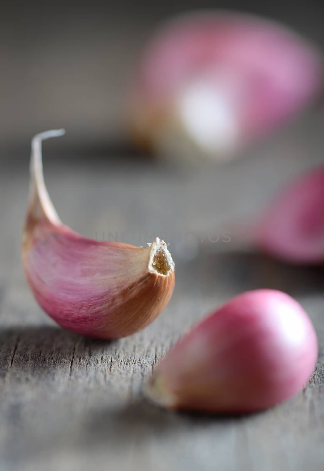 Garlic cloves on wooden background