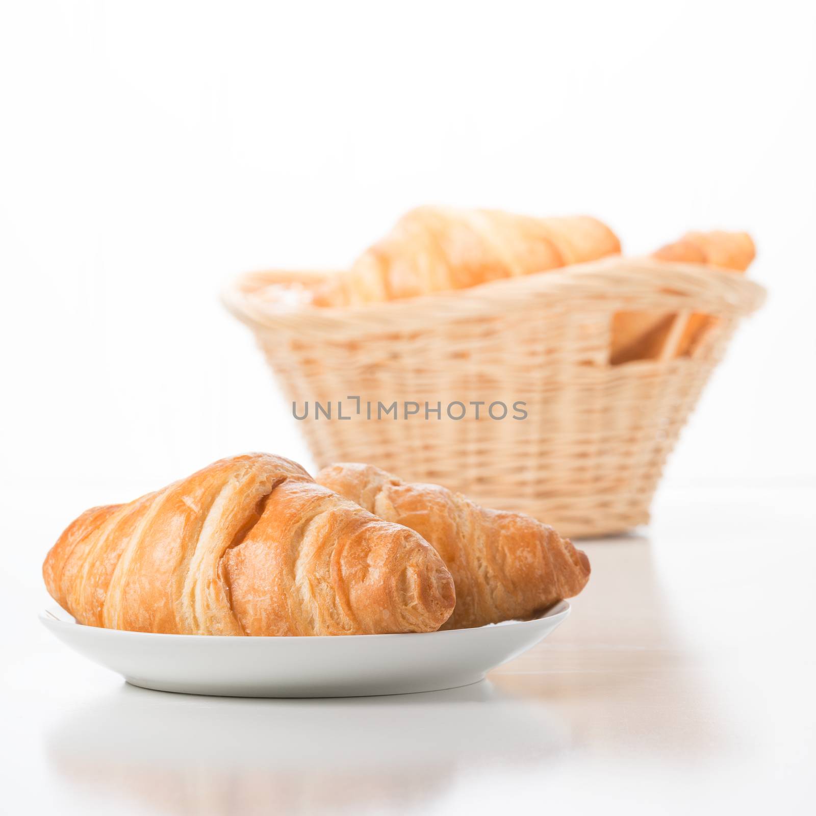 Fresh baked croissants against a white background.