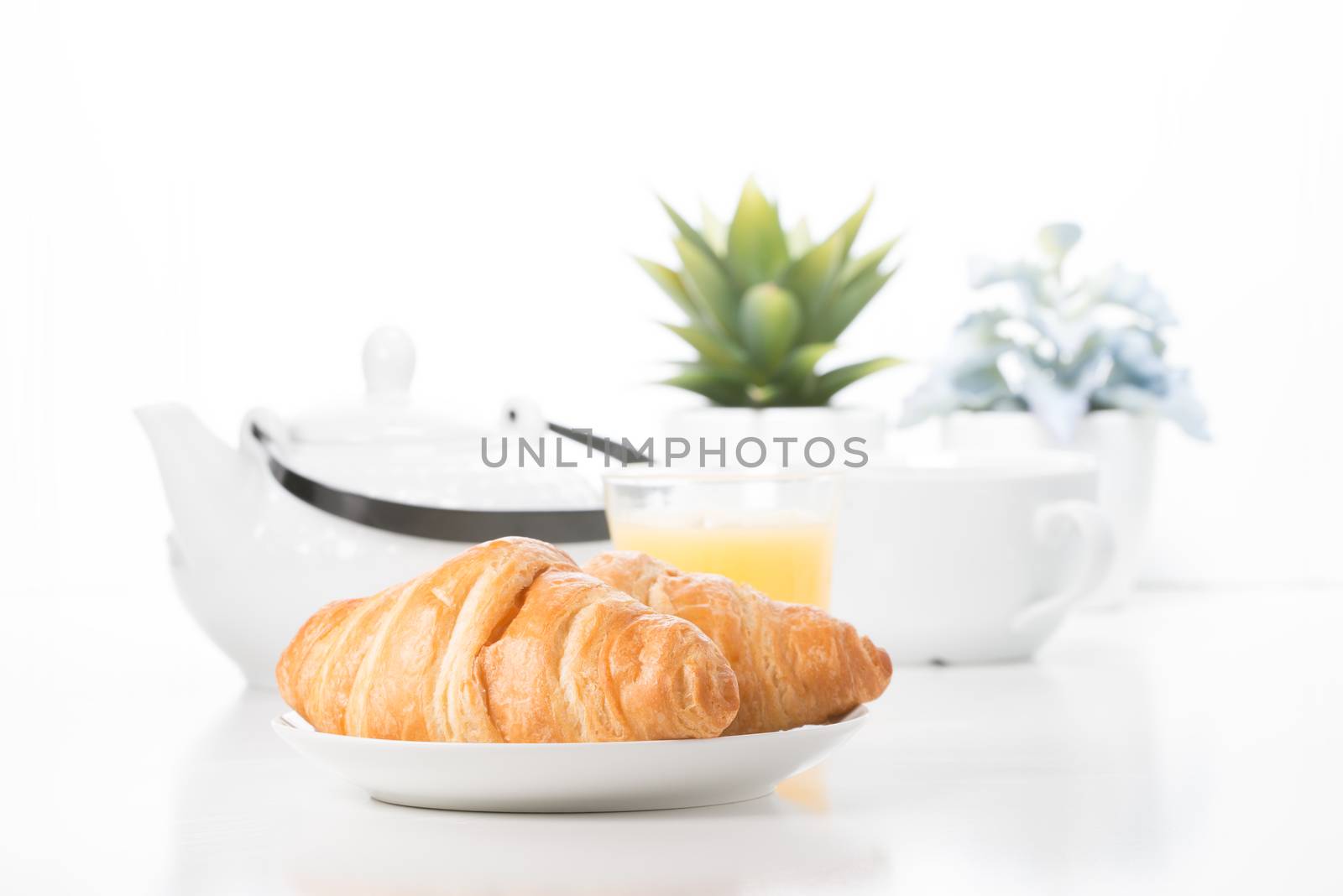 Delicate croissants presented in a breakfast type setting.