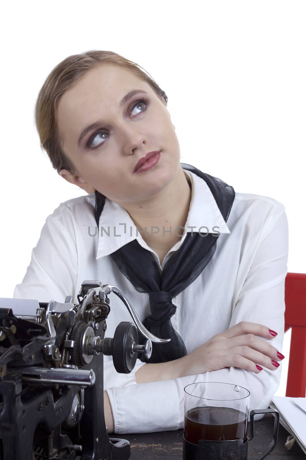 Young girl typist with an old typewriter on a white background