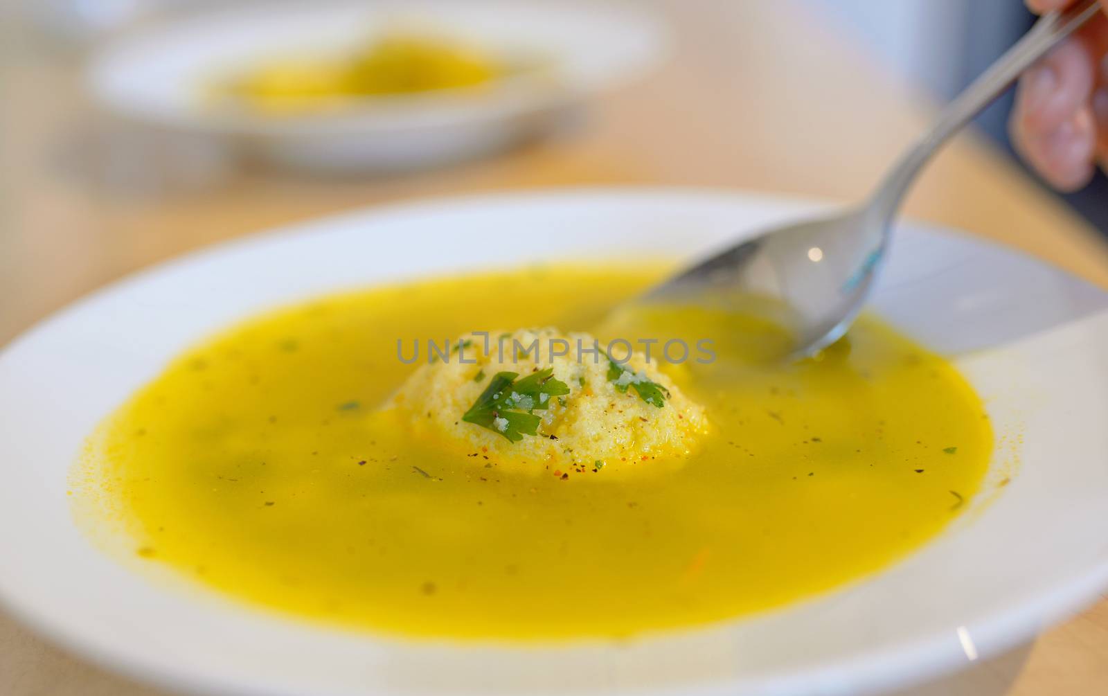 Soup with dumplings on table