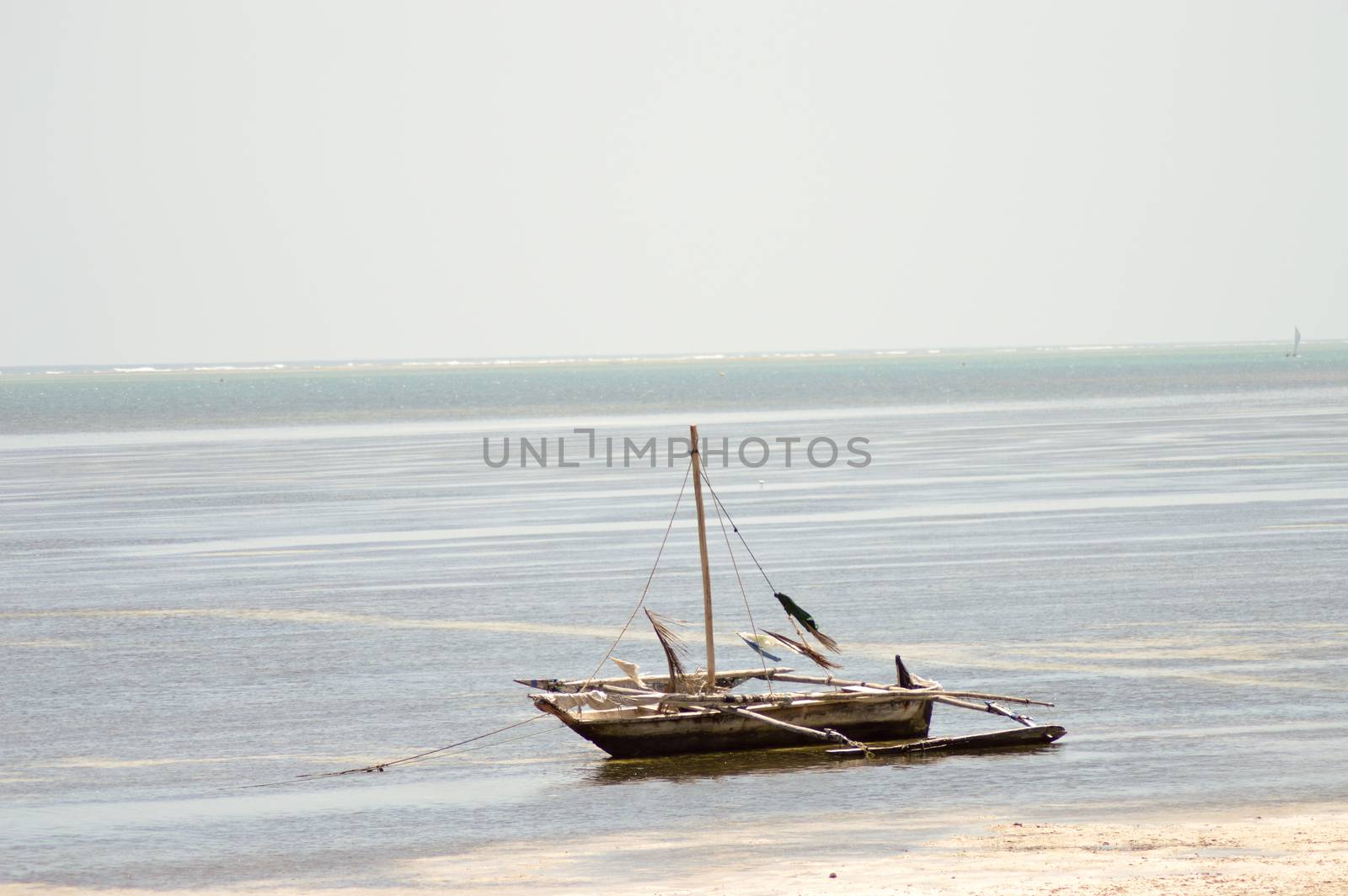 Sail without a sail on the sand during the falling tide on the Indian Ocean