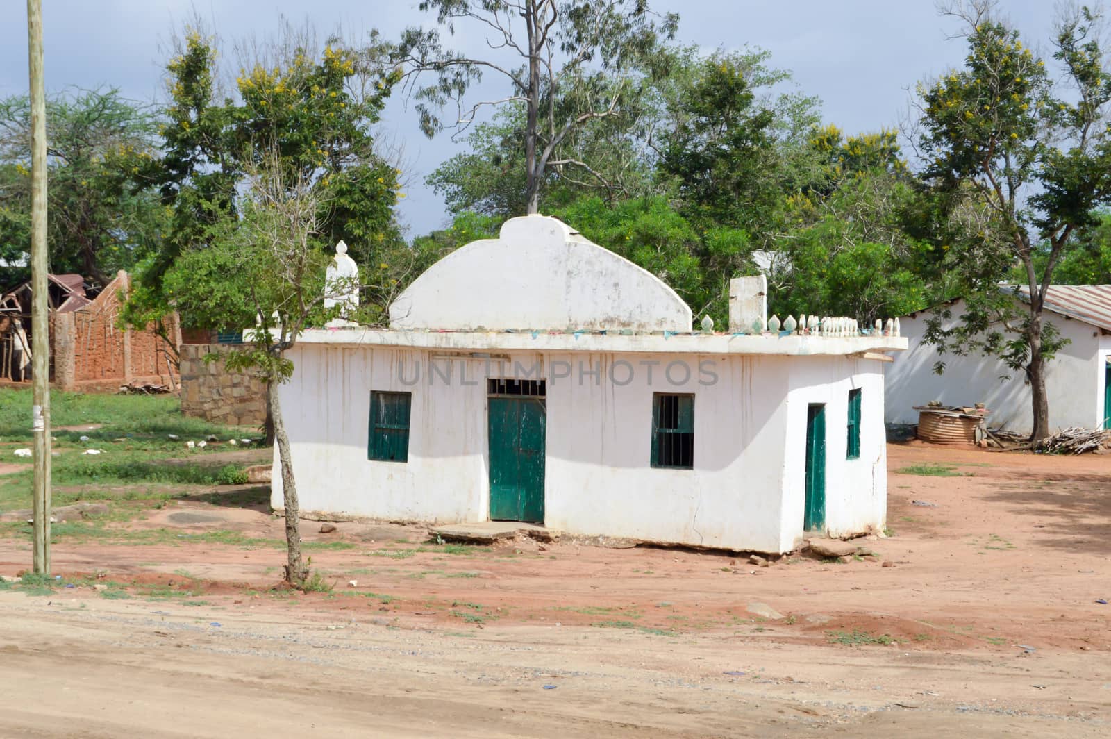 Small white and green house in the Kenyan countryside