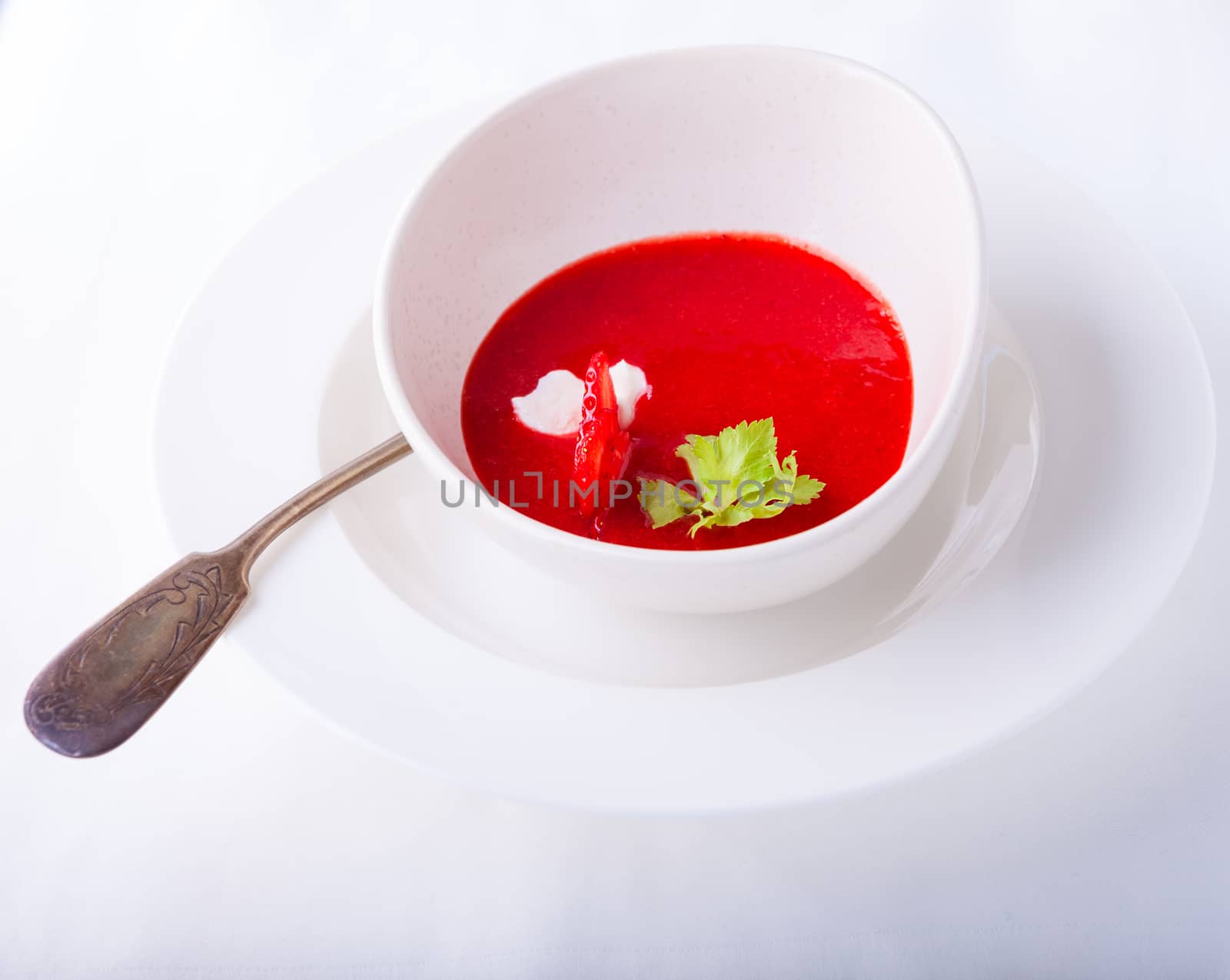 Strawberry soup with a spoon on a white background by supercat67