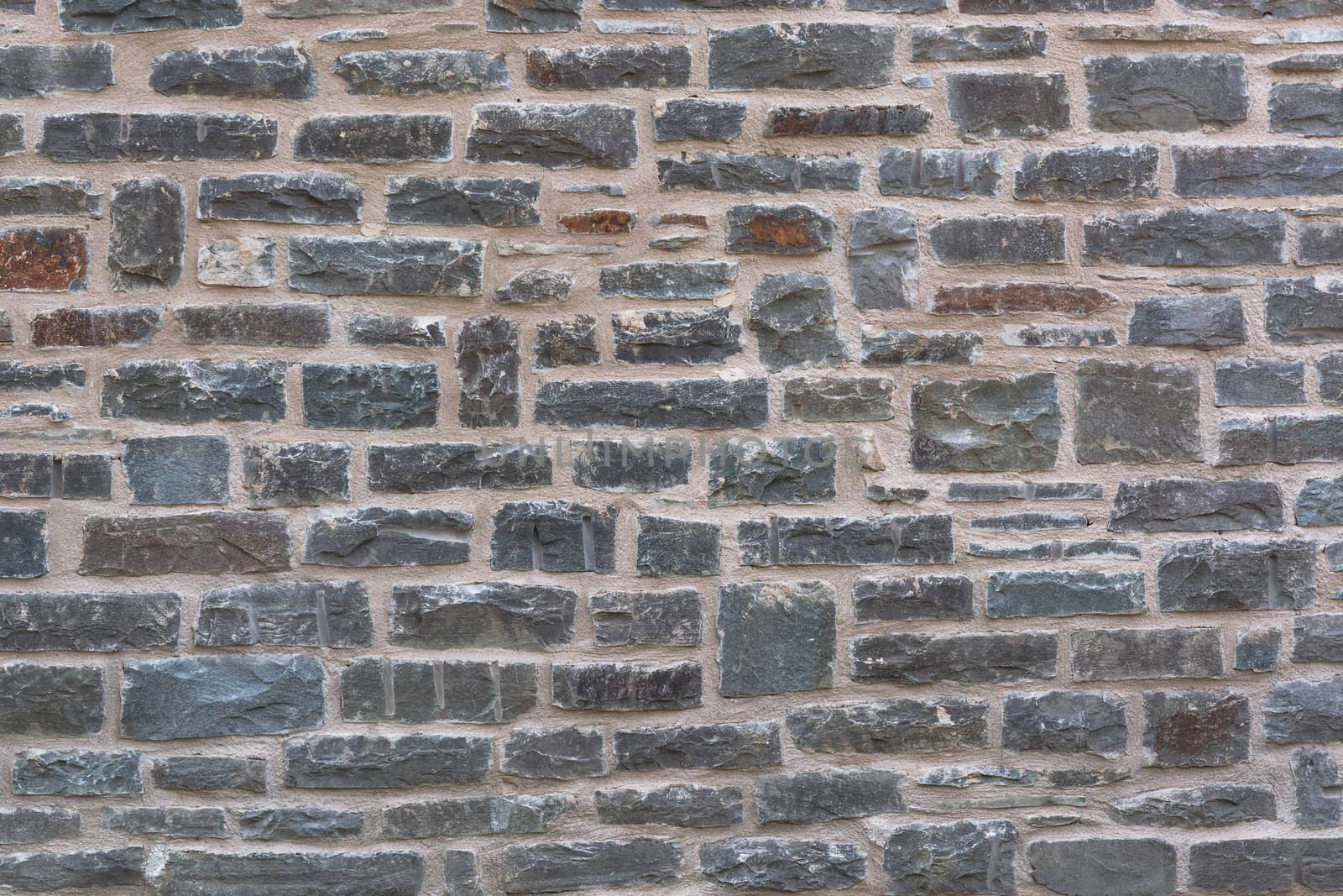 Background, old broken stone wall with relief texture and shadows.