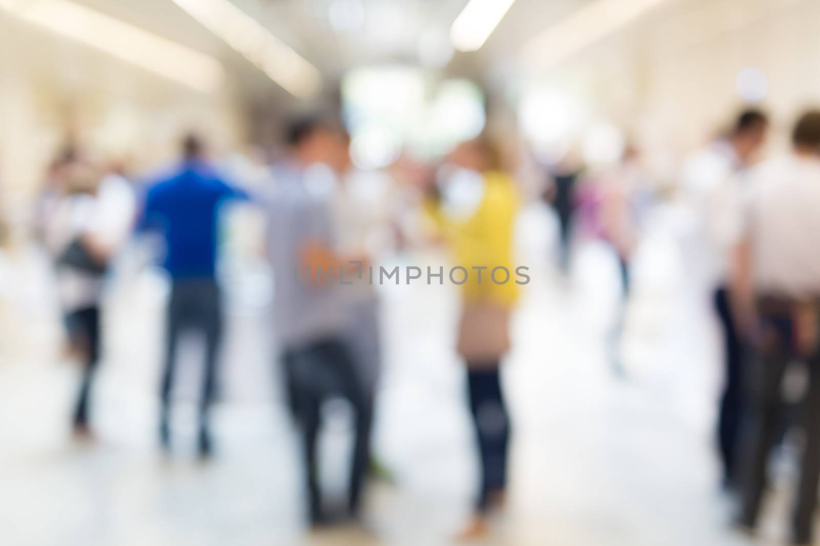 Abstract blurred people socializing during coffee break at business meeting or conference.