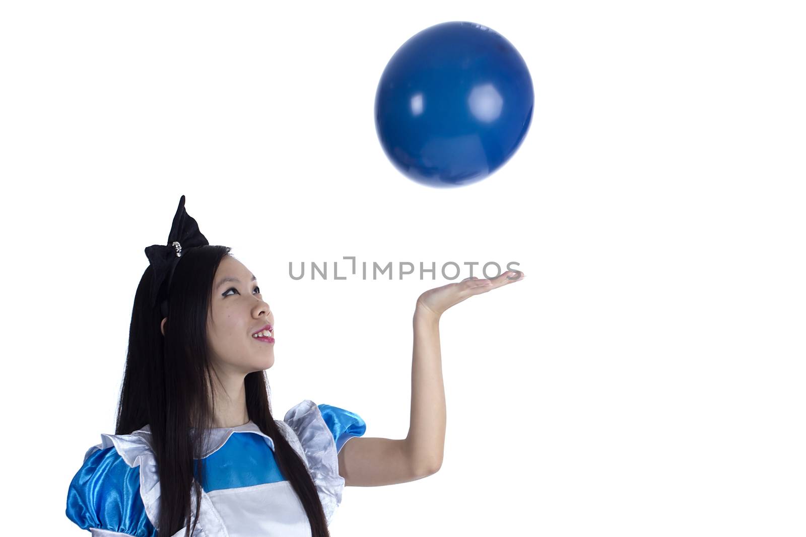 Young girl in the image of Alice with blue ball